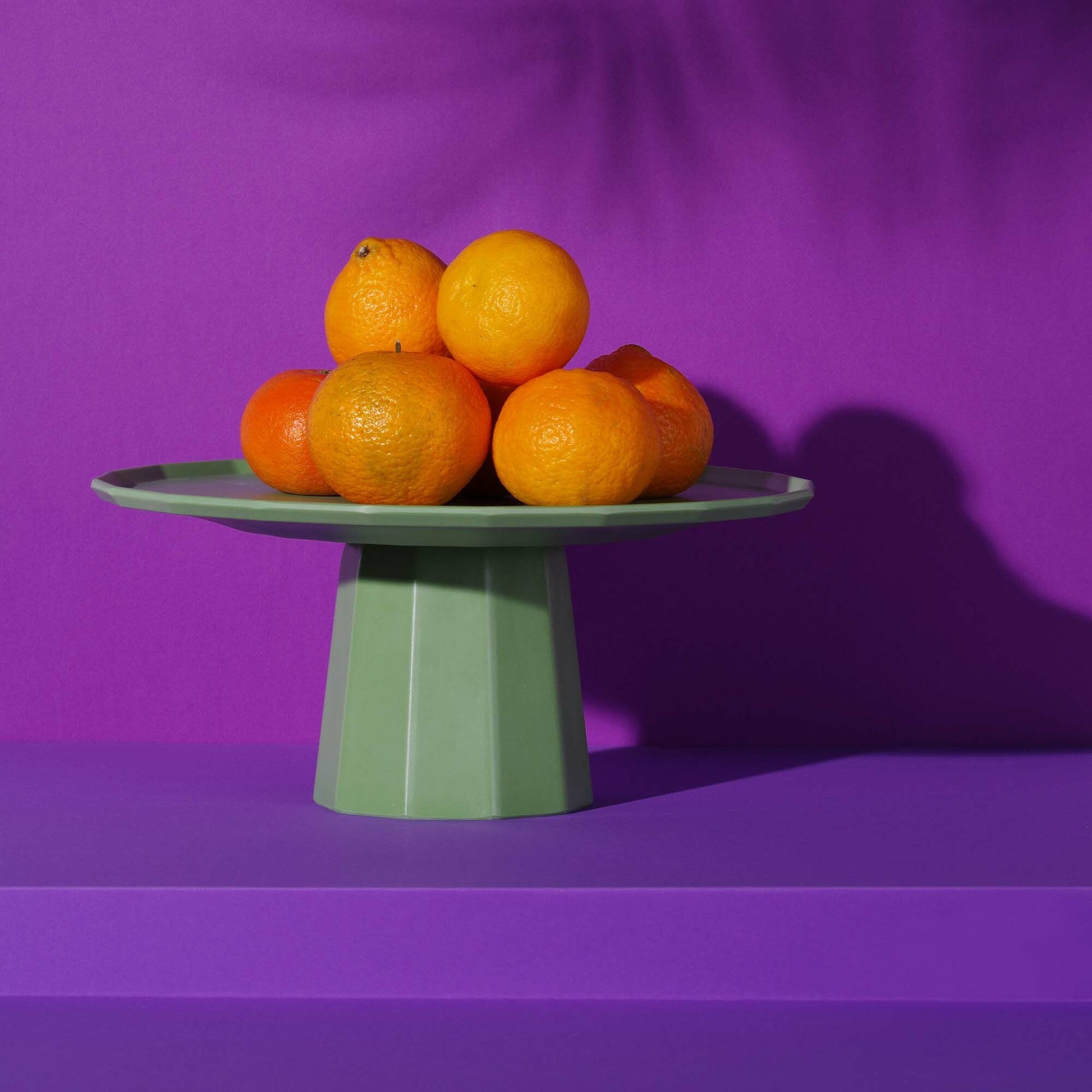 Green Fine Dine Metropolis fruit stand platter, 300mm diameter, with a sleek modern design and spacious surface for fruit display.